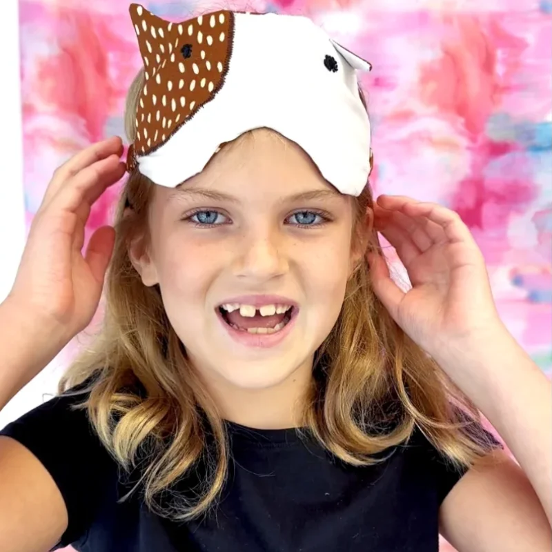 Girl proudly wearing her handmade accessory created at summer sewing camp