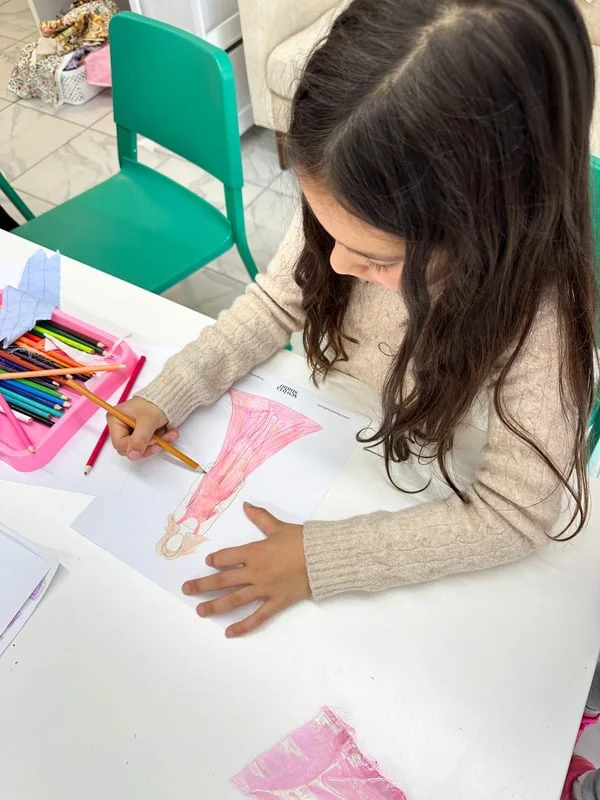 Kids learning to sew with colorful thread spools at Sewista Studio Sarasota
