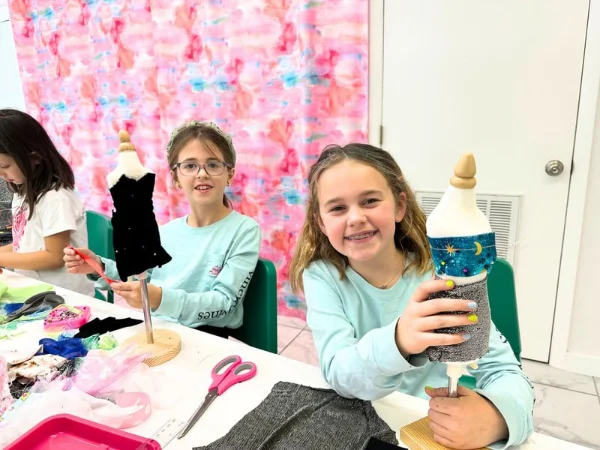 Kids learning fabric cutting techniques at Sewista Studio sewing class